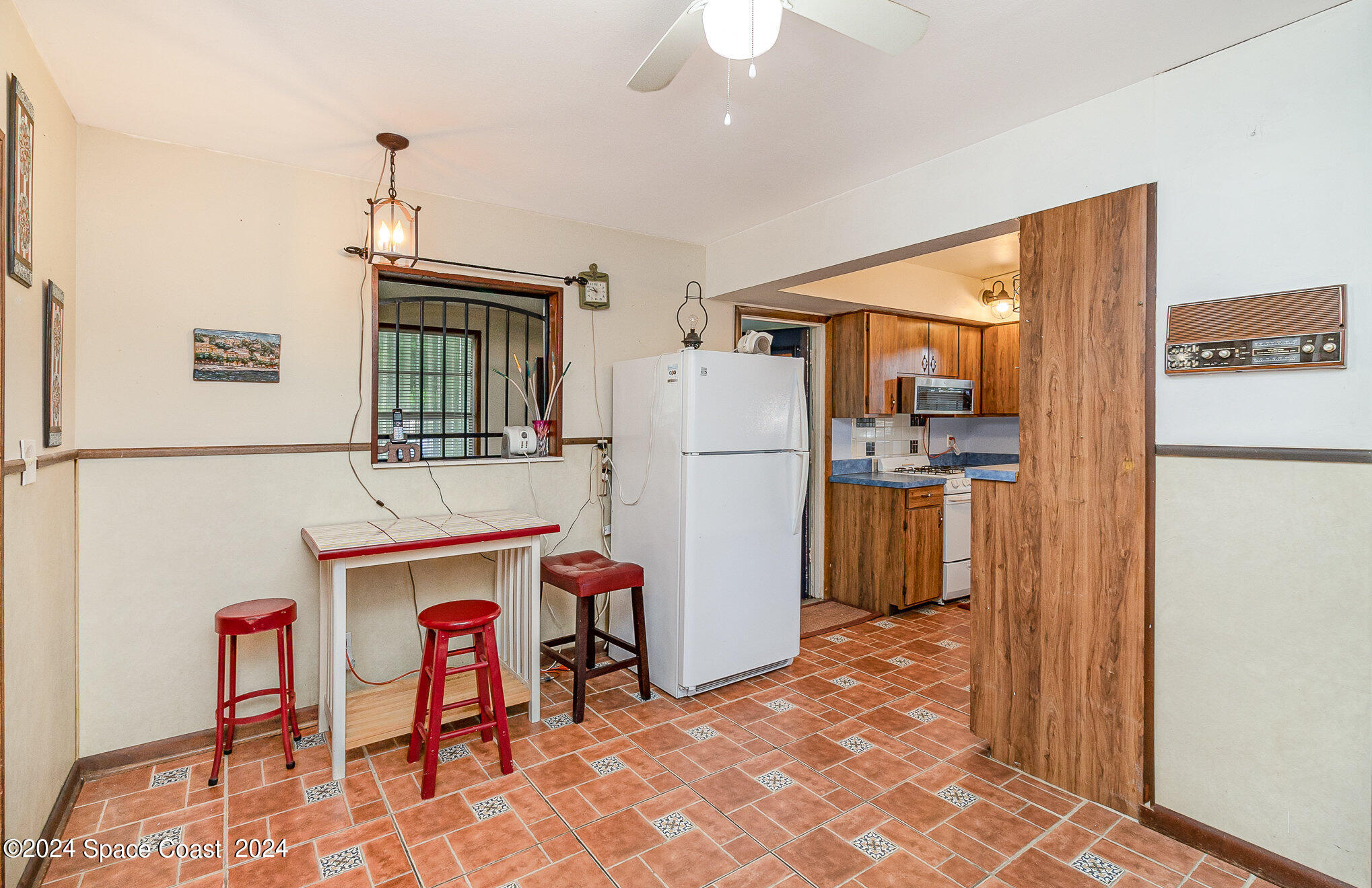 1707 Platt Street Melbourne, FL 32901 - Photo 8 of 32 a kitchen with stainless steel appliances a refrigerator and a stove top oven
