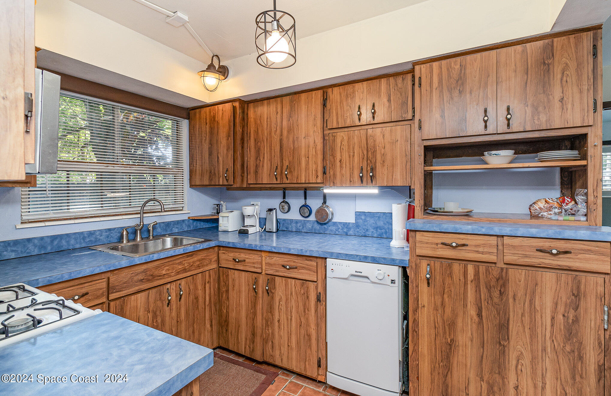 1707 Platt Street Melbourne, FL 32901 - Photo 9 of 32 a kitchen with stainless steel appliances granite countertop a sink dishwasher stove and cabinets with wooden floor