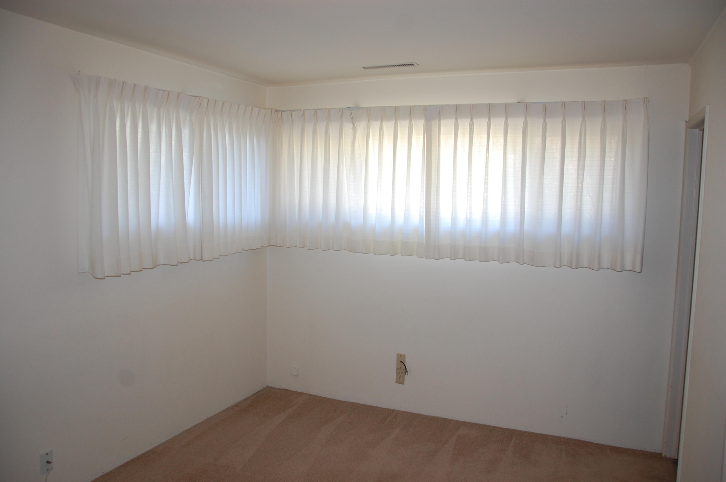 3933 Foothill Road Santa Barbara, CA 93110 - Photo 12 of 28 wooden floor in an empty room with a window