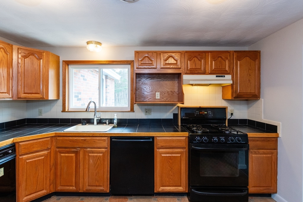 25 Ruthellen Road Framingham, MA 01701 - Photo 11 of 36 a kitchen with stainless steel appliances granite countertop a sink stove and cabinets