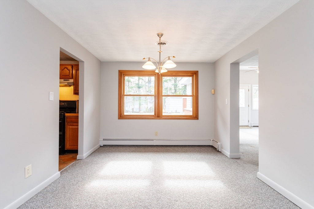 25 Ruthellen Road Framingham, MA 01701 - Photo 8 of 36 an empty room with windows and chandelier