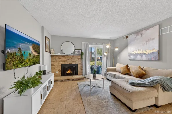 a living room with furniture and a fireplace