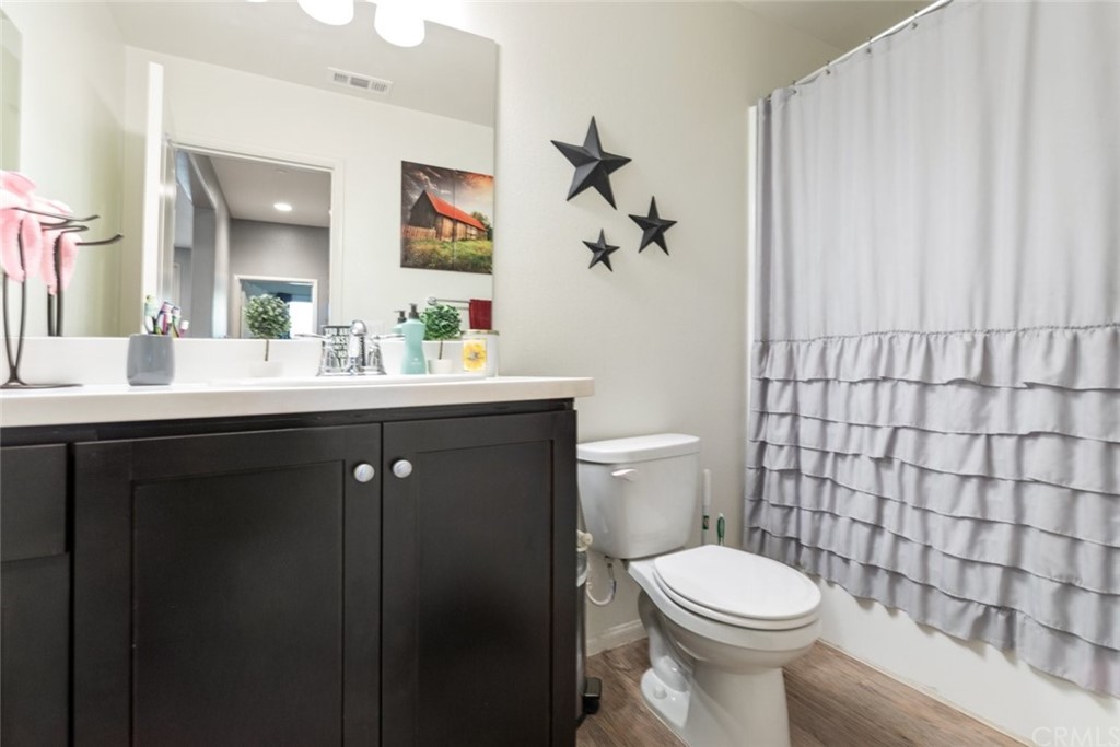 24802 Sandy Trail Place Menifee, CA 92584 - Photo 12 of 42 a bathroom with a sink a toilet and shower