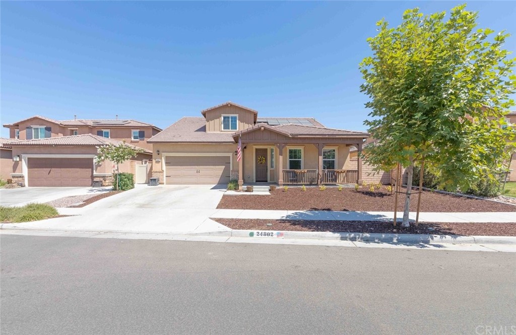24802 Sandy Trail Place Menifee, CA 92584 - Photo 2 of 42 a front view of a house with a yard and a garage