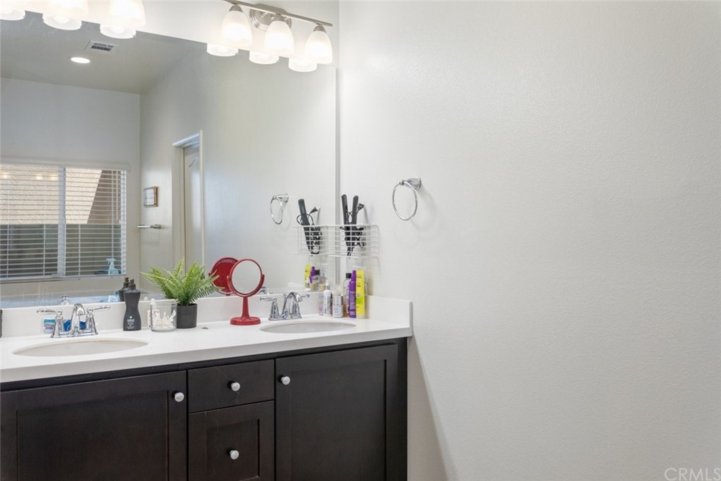 24802 Sandy Trail Place Menifee, CA 92584 - Photo 23 of 42 a bathroom with a sink and a mirror