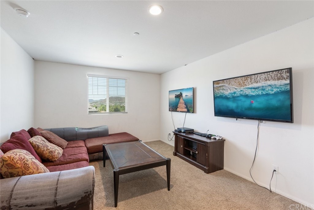 24802 Sandy Trail Place Menifee, CA 92584 - Photo 25 of 42 a living room with furniture and a flat screen tv
