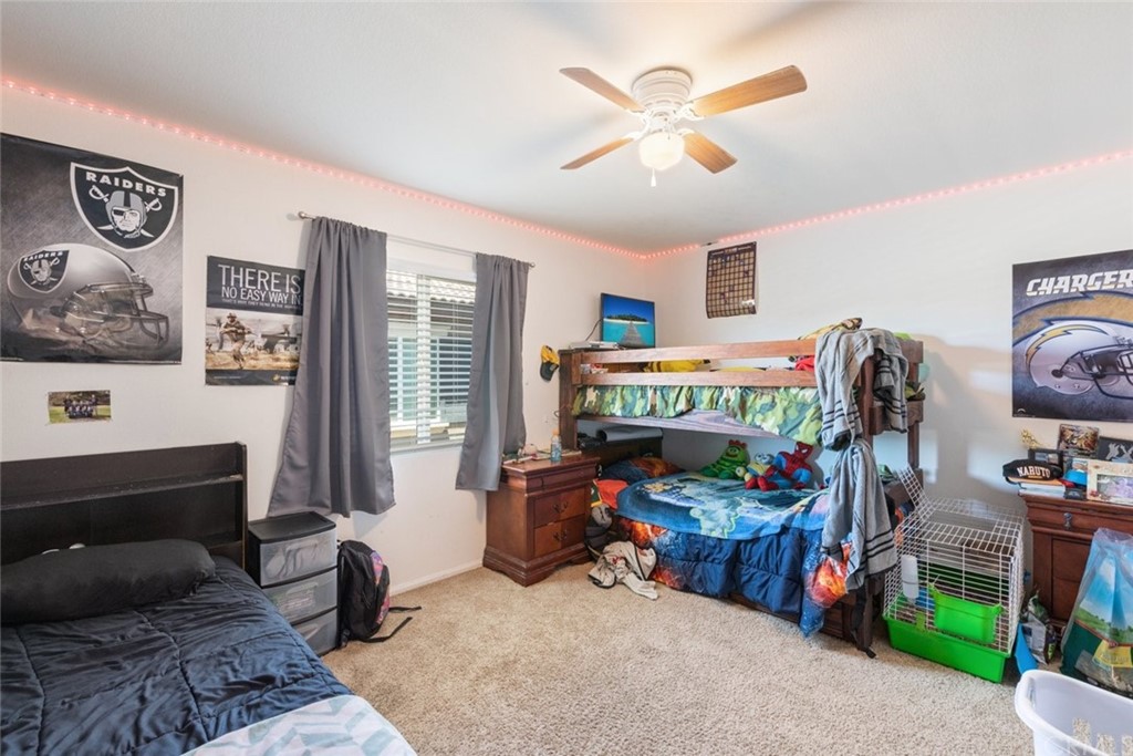 24802 Sandy Trail Place Menifee, CA 92584 - Photo 26 of 42 a bedroom with furniture and a fan