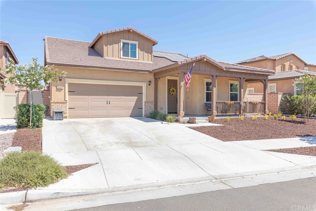 24802 Sandy Trail Place Menifee, CA 92584 - Photo 3 of 42 a front view of a house with a yard and garage