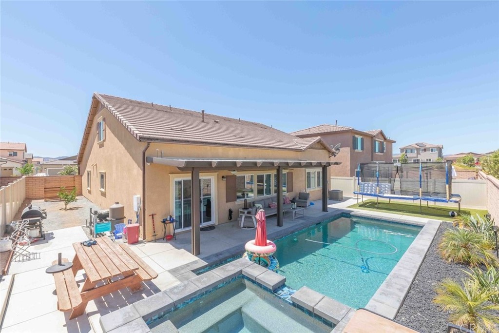 24802 Sandy Trail Place Menifee, CA 92584 - Photo 31 of 42 a view of a patio with dining table and chairs