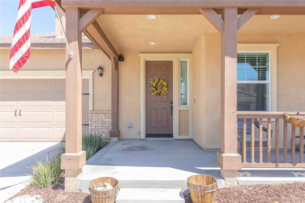 24802 Sandy Trail Place Menifee, CA 92584 - Photo 6 of 42 a front view of a house with a yard