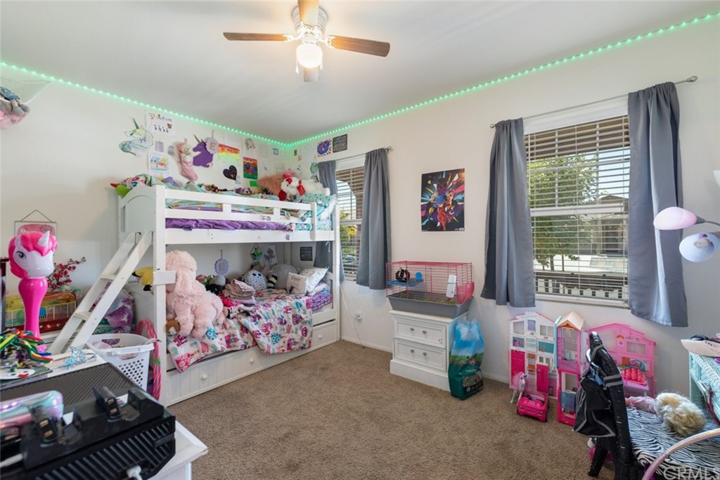 24802 Sandy Trail Place Menifee, CA 92584 - Photo 10 of 42 a bedroom with lots of furniture and a couch