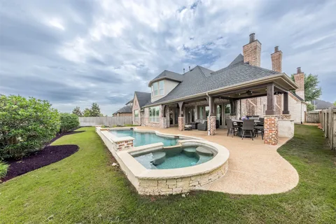 a swimming pool with outdoor seating yard and barbeque oven
