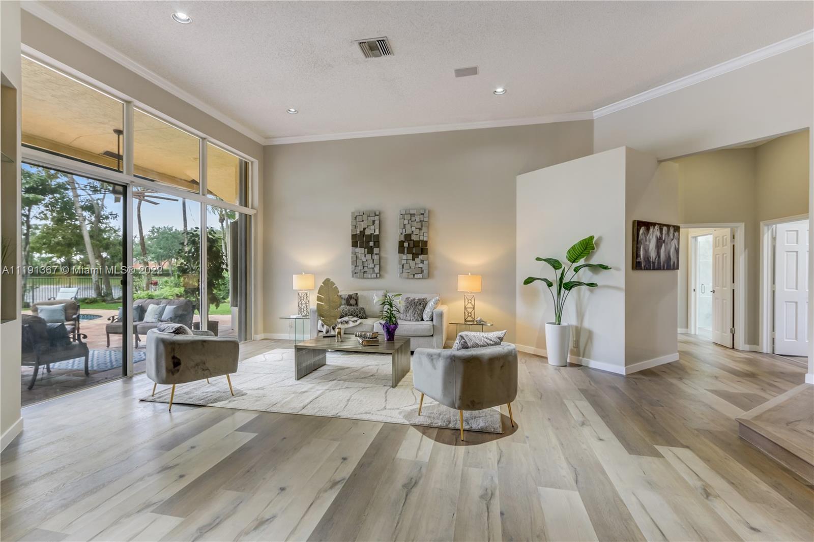 300 Mallard Road Weston, FL 33327 - Photo 15 of 46 a living room with furniture large windows and wooden floor