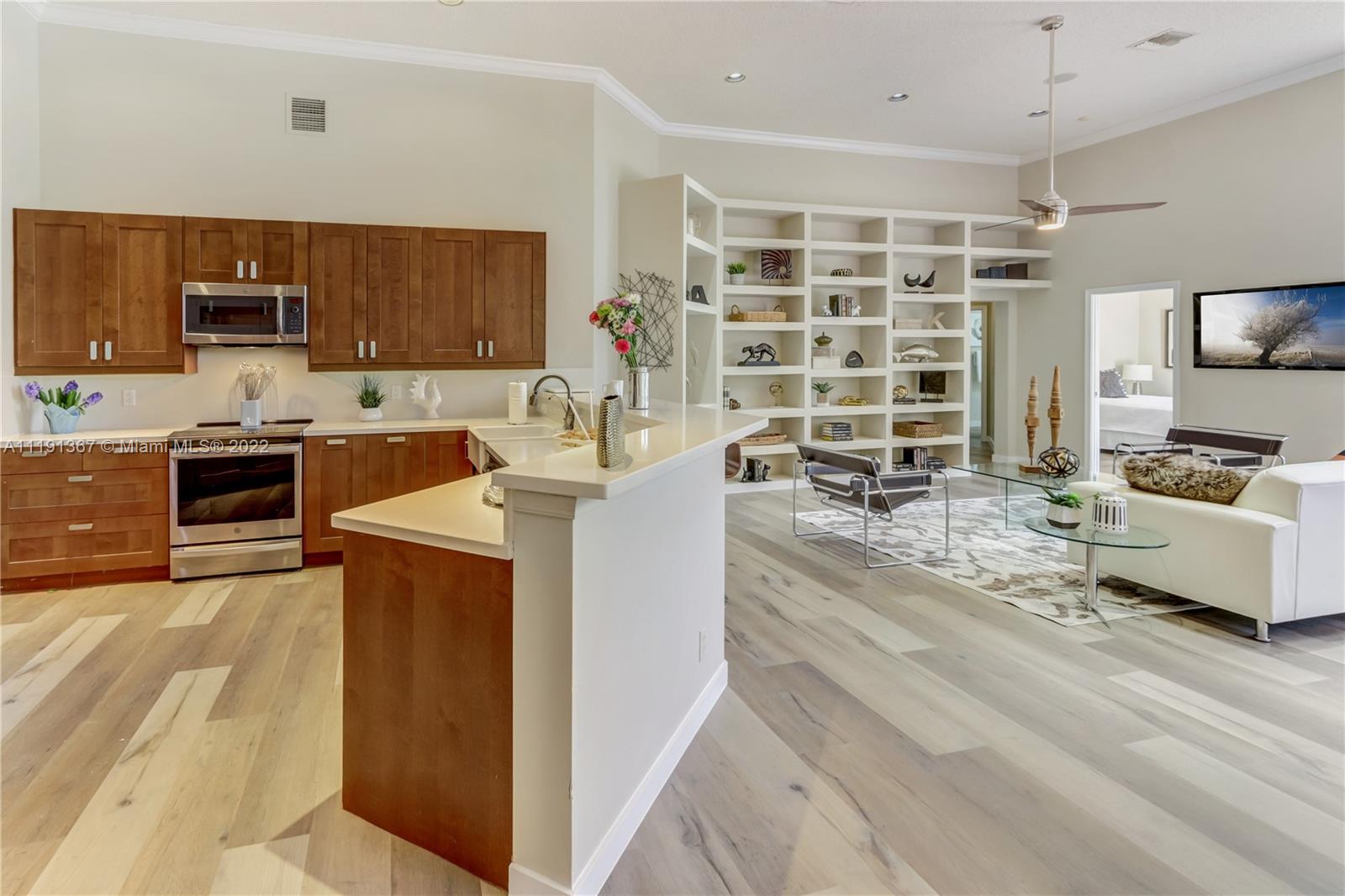 300 Mallard Road Weston, FL 33327 - Photo 19 of 46 a living room with stainless steel appliances kitchen island granite countertop a sink and a refrigerator
