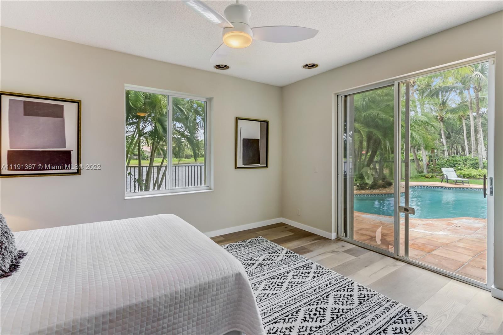 300 Mallard Road Weston, FL 33327 - Photo 27 of 46 a bedroom with a large bed and a window