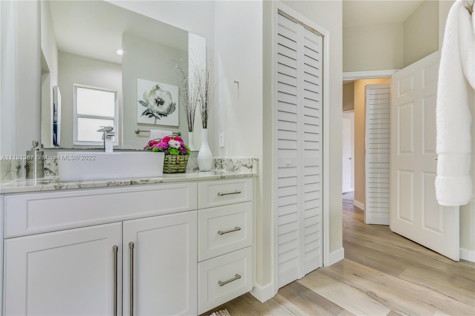 300 Mallard Road Weston, FL 33327 - Photo 30 of 46 a bathroom with a granite countertop sink and a mirror