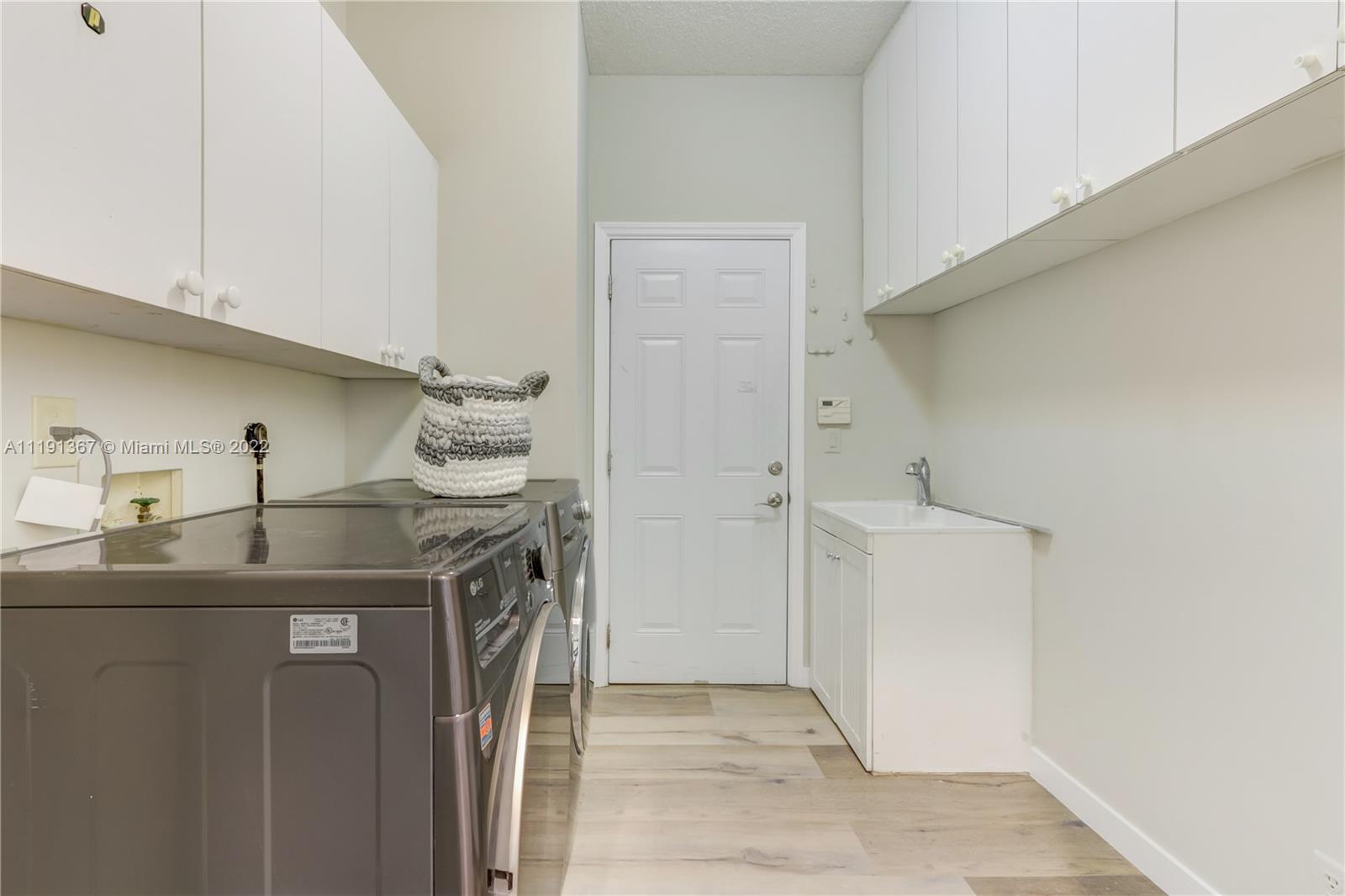 300 Mallard Road Weston, FL 33327 - Photo 33 of 46 a kitchen with a sink stove and refrigerator