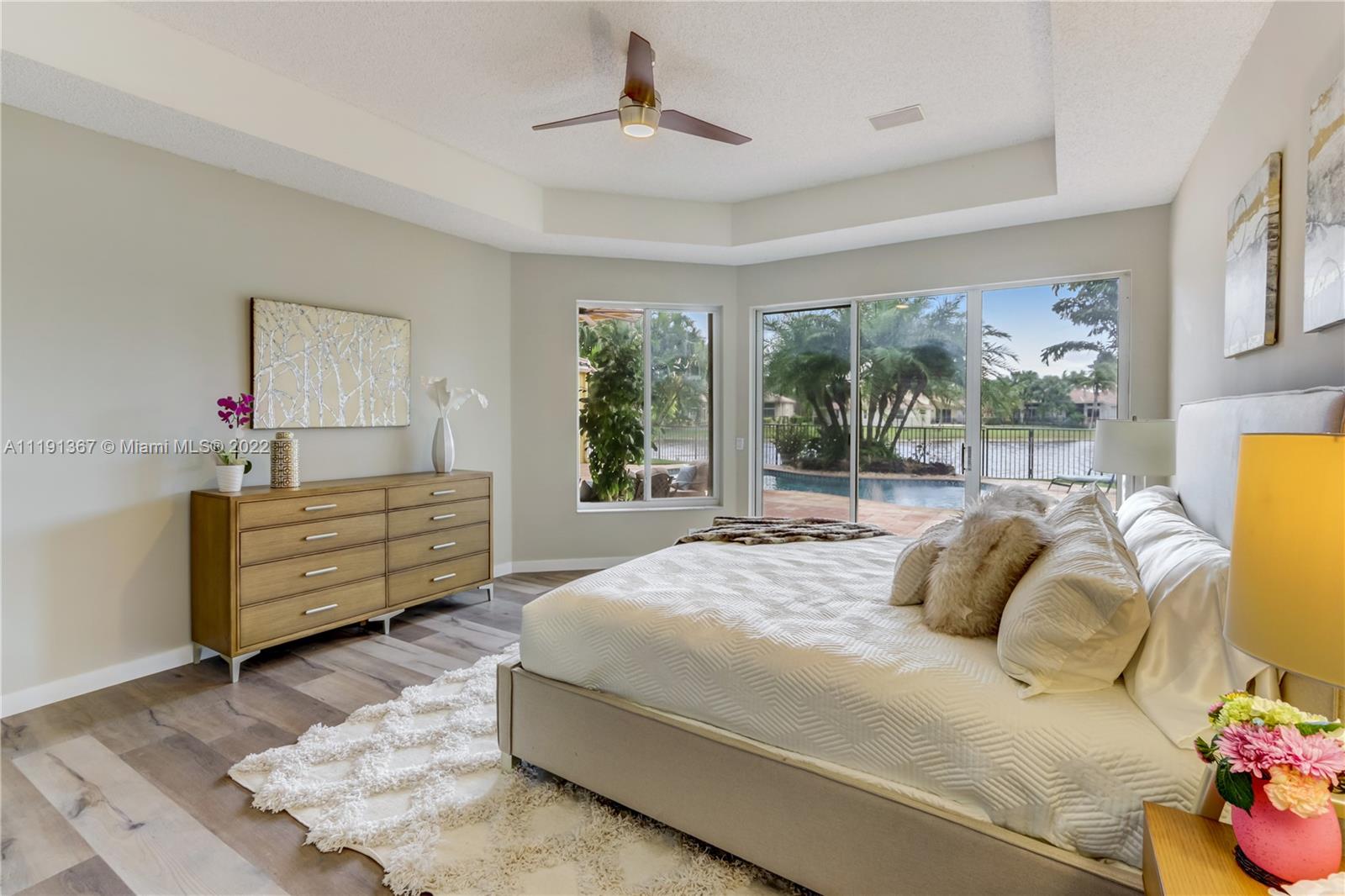 300 Mallard Road Weston, FL 33327 - Photo 35 of 46 a bedroom with a bed and large windows