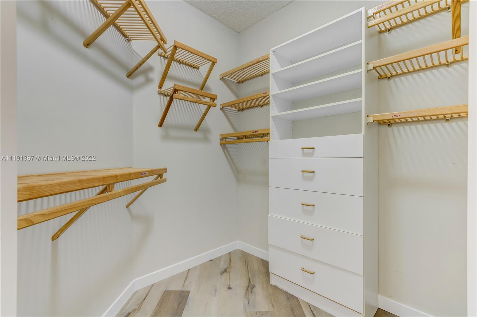 300 Mallard Road Weston, FL 33327 - Photo 40 of 46 a view of walk in closet with empty racks