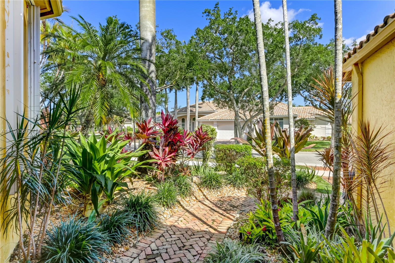 300 Mallard Road Weston, FL 33327 - Photo 5 of 46 a backyard of a house with a garden and outdoor seating