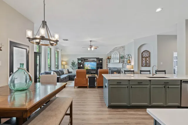 a large kitchen with a table and chairs