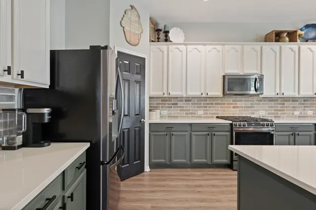 a kitchen with a refrigerator and a sink