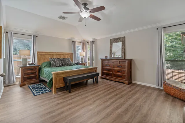 a bedroom with furniture and wooden floor