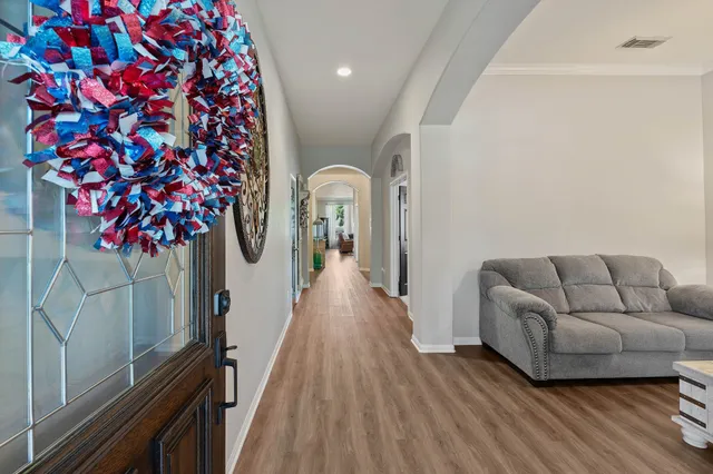 a living room with furniture and a potted plant