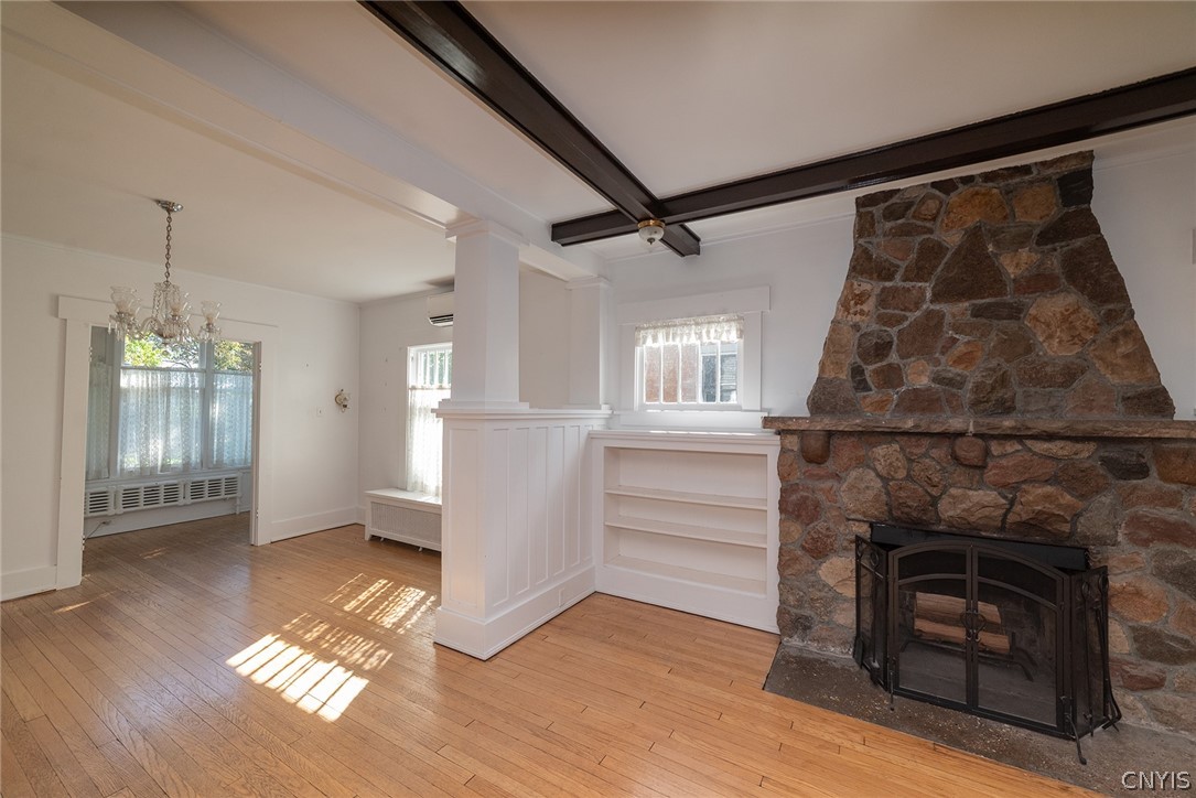 167 Beverly Road Syracuse, NY 13207 - Photo 9 of 50 Exposed ceiling beams and a stone fireplace bring classic character to this warm living space.