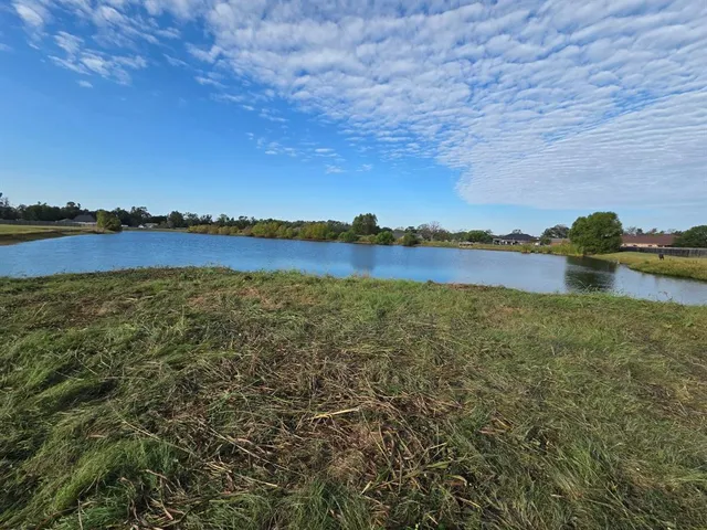 a view of a lake with houses in the back