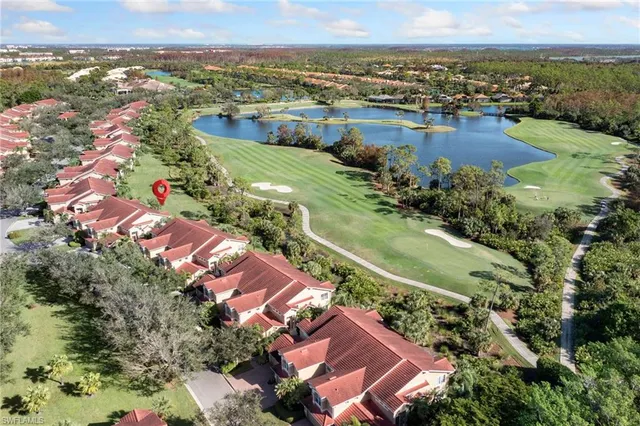 an aerial view of residential houses with outdoor space and river