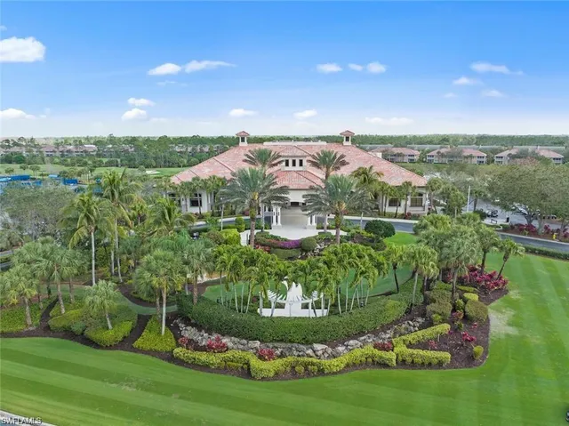 a view of a house with a big yard and potted plants in front of it