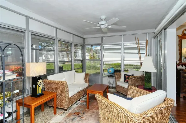 a living room with furniture and a view of bedroom