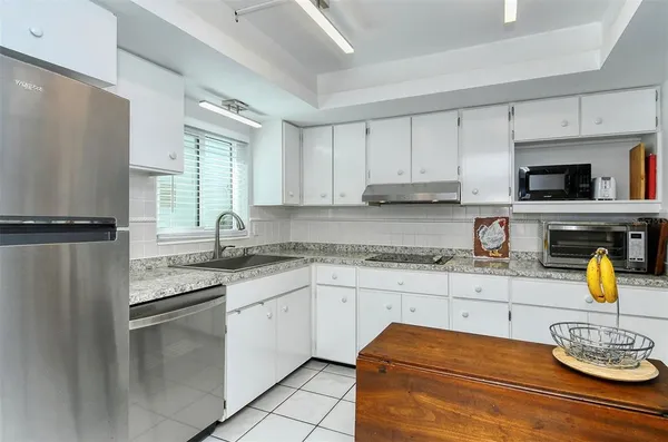 a kitchen with a stove a sink and a microwave