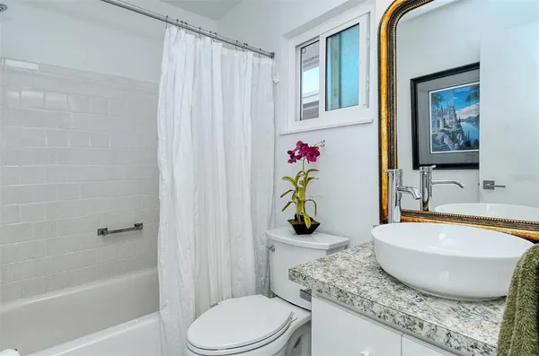 a room with stainless steel appliances furniture and a window