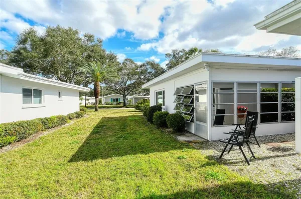 a view of a house with a backyard
