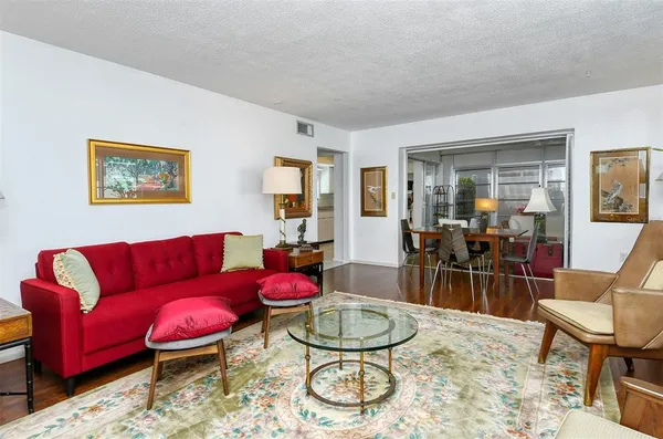 a view of a dining room with furniture and wooden floor