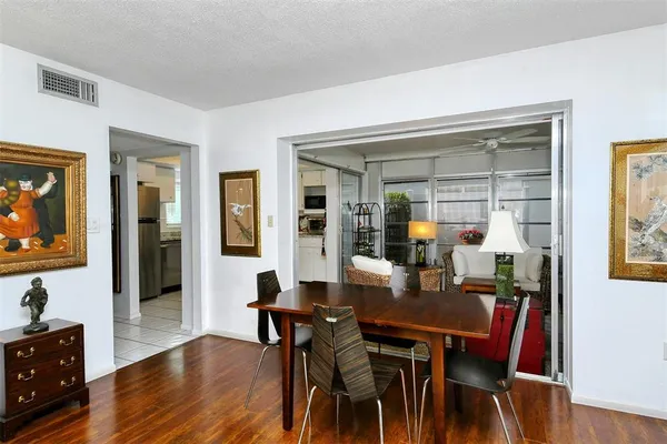 a living room with furniture two lamps and wooden floor