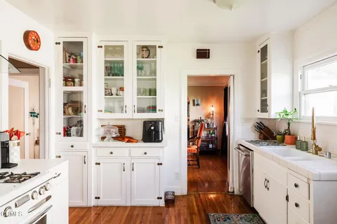 a kitchen with stainless steel appliances a stove top oven and a refrigerator