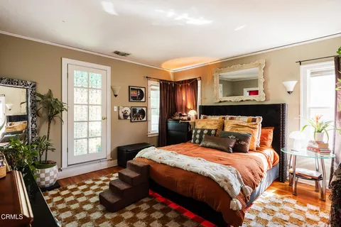 a bedroom with a large bed and a window