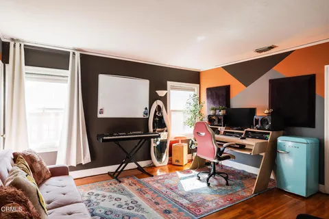 a view of a workspace with furniture and a window
