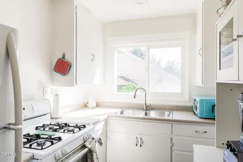 a kitchen with a sink stove and cabinets
