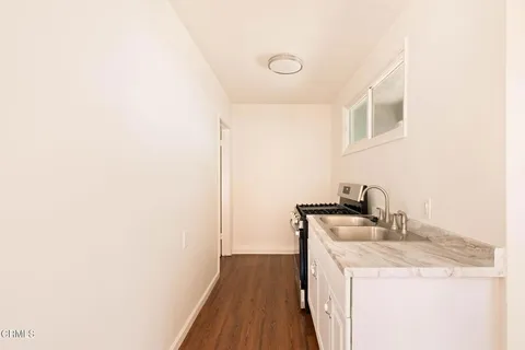 a kitchen with a sink and a refrigerator