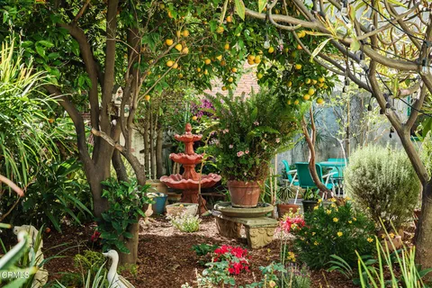 a backyard of a house with table and chairs