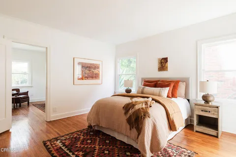 a bedroom with bed and wooden floor