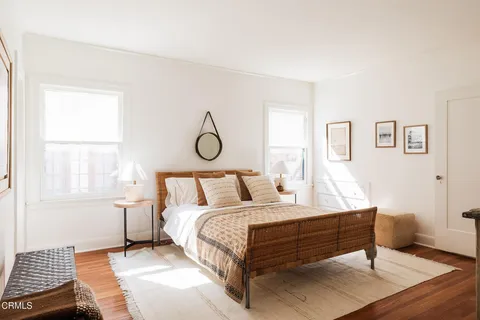 a bed sitting in a bedroom next to a window