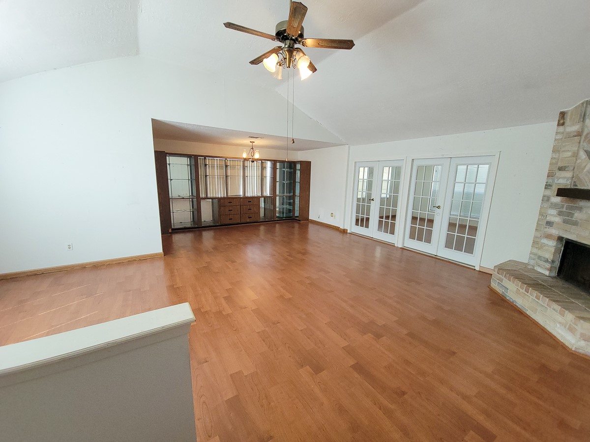 3430 Hombly Road Houston, TX 77066 - Photo 11 of 20 an empty room with chandelier fan and windows
