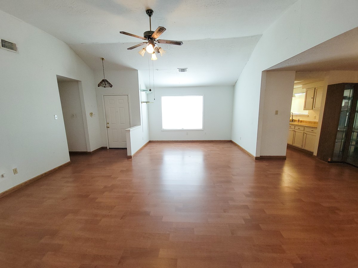 3430 Hombly Road Houston, TX 77066 - Photo 13 of 20 an empty room with wooden floor and windows