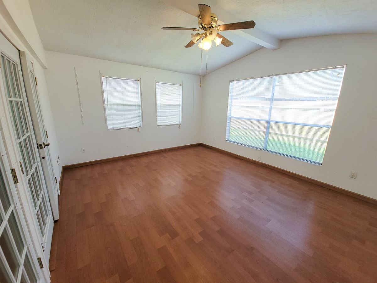 3430 Hombly Road Houston, TX 77066 - Photo 14 of 20 a view of an empty room with a window and wooden floor