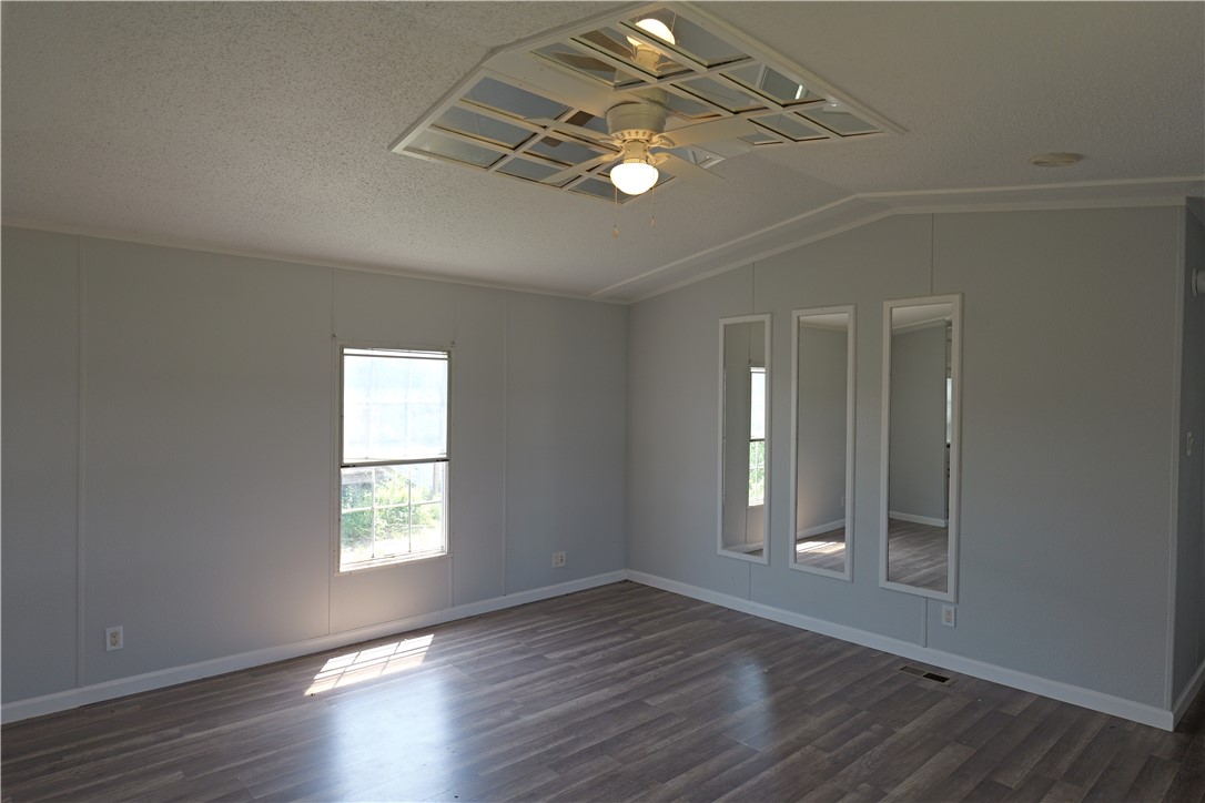 732 B Rogers Street Normangee, TX 77871 - Photo 2 of 9 an empty room with wooden floor and windows